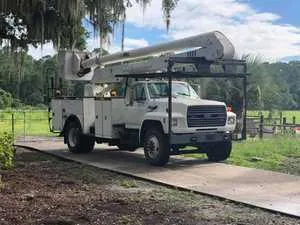 The Wood Doctor truck loaded with tree debris for hauling in Gainesville, FL